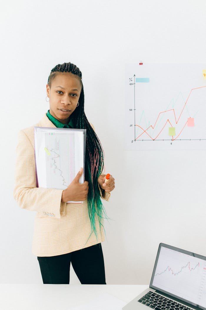 Confident analyst presenting financial data and growth charts in a modern office setting.